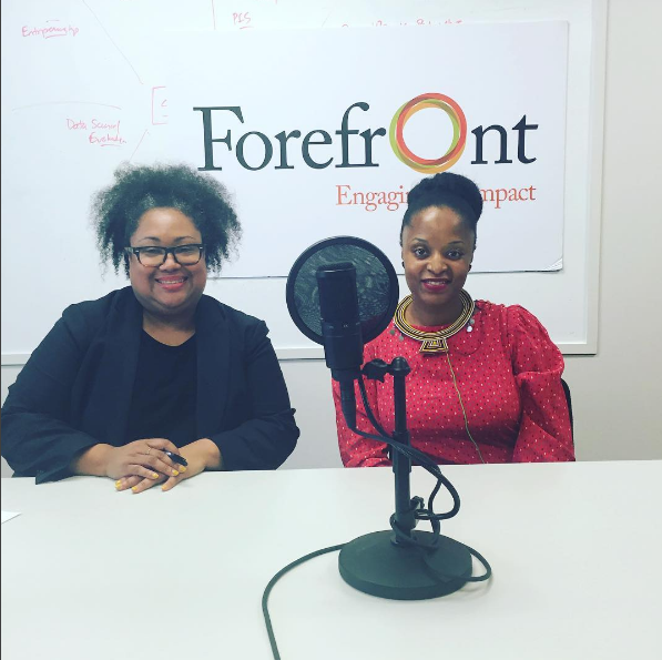 Ayesha Jaco and Delia Coleman seated in front of Forefront Logo